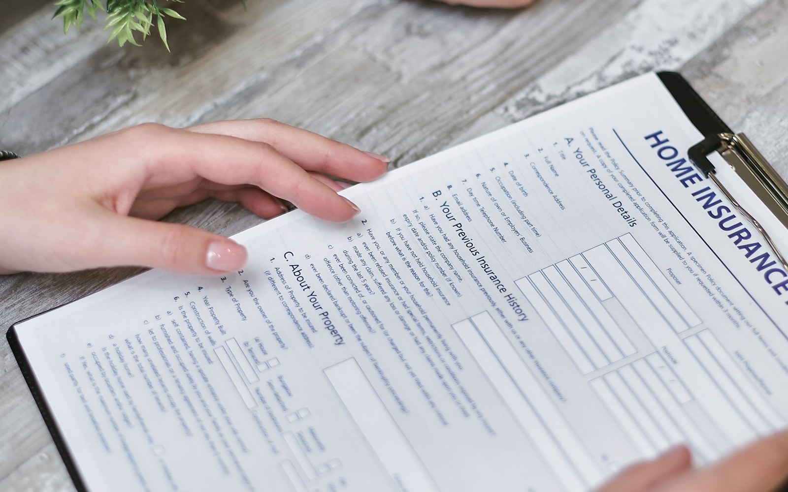 A printed copy of the January 2025 Federal Register nicotine product standard notice open to the proposed maximum-content figure, held by an adult's hands against a desk surface